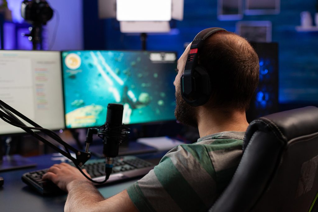 concentrated gamer playing shooter game